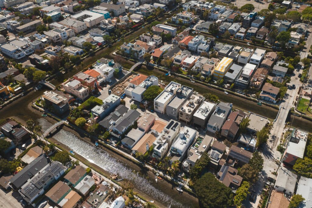 A scenic aerial shot showcasing a residential neighborhood with a canal running through it.
