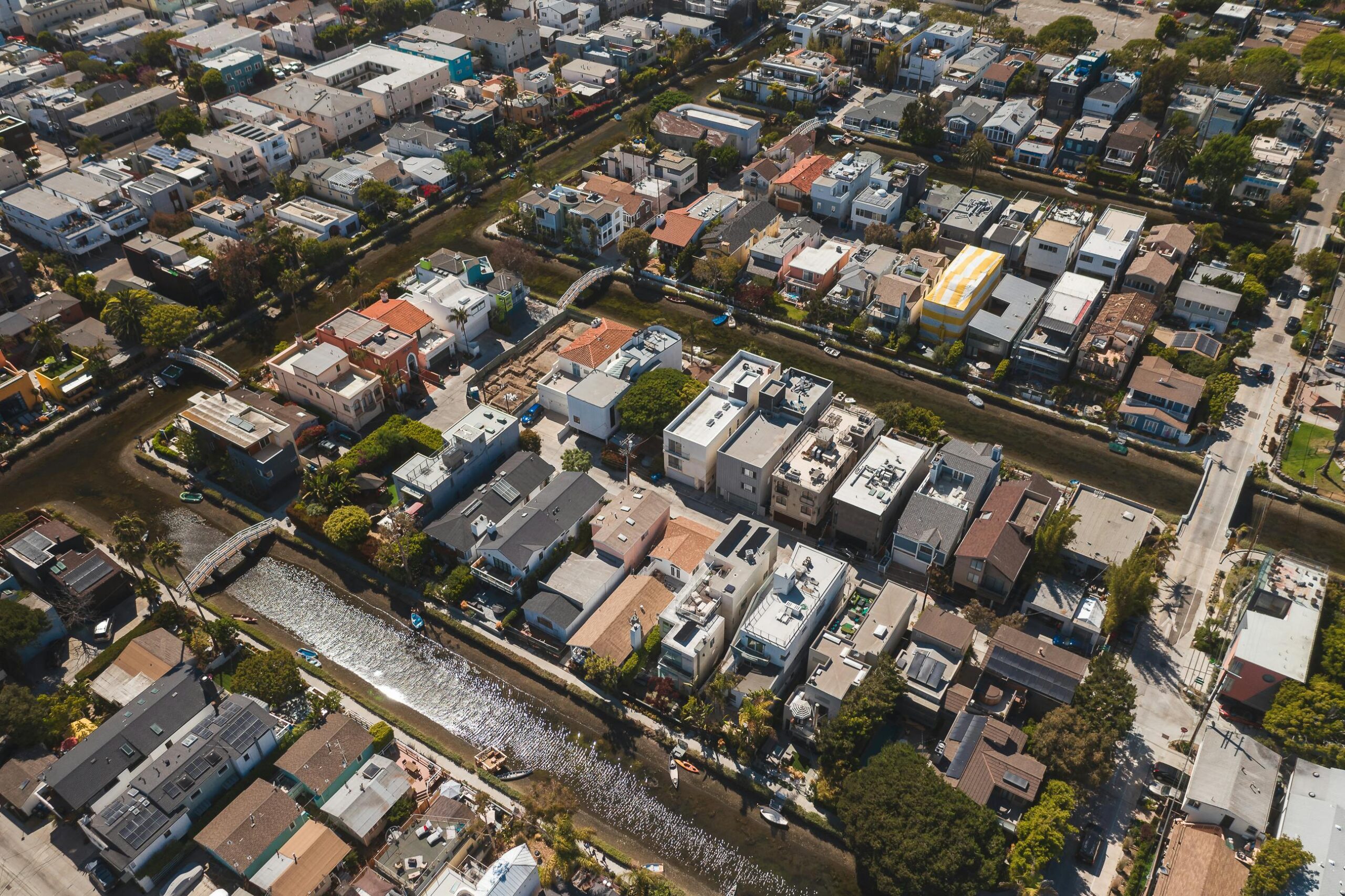 A scenic aerial shot showcasing a residential neighborhood with a canal running through it.